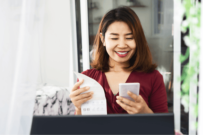 Woman looking happy and satisfied at medical bill