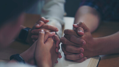 a group sharing a prayer for strength and encouragement