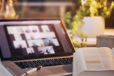 entrepreneur reading scripture for business owners to motivate team during virtual business meeting